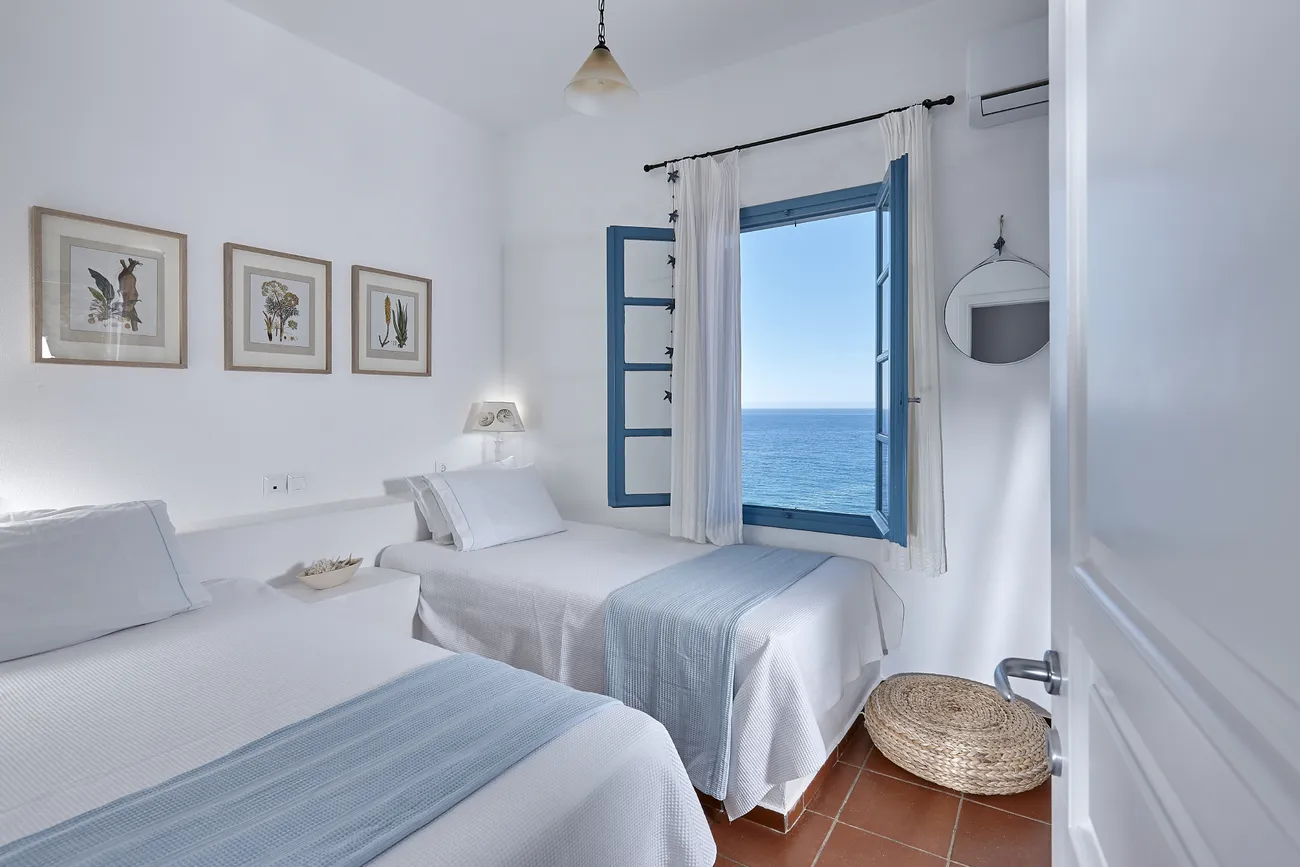Guest bedroom of Naya with a sea-view window