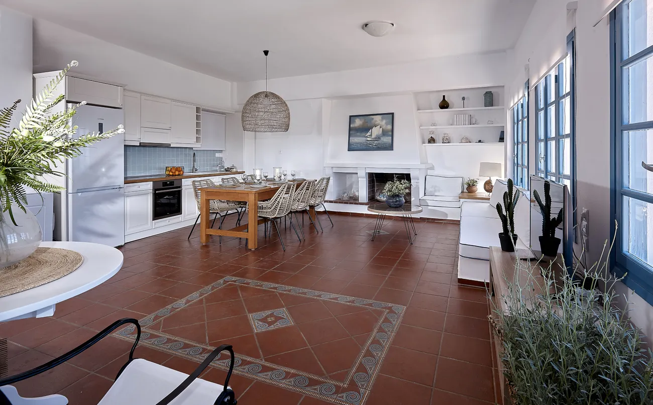 White living room of Naya with fireplace and sea views