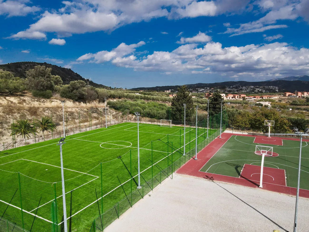 Football pitch and basketball court of Evgeniki Stadium with the Cretan hills behind