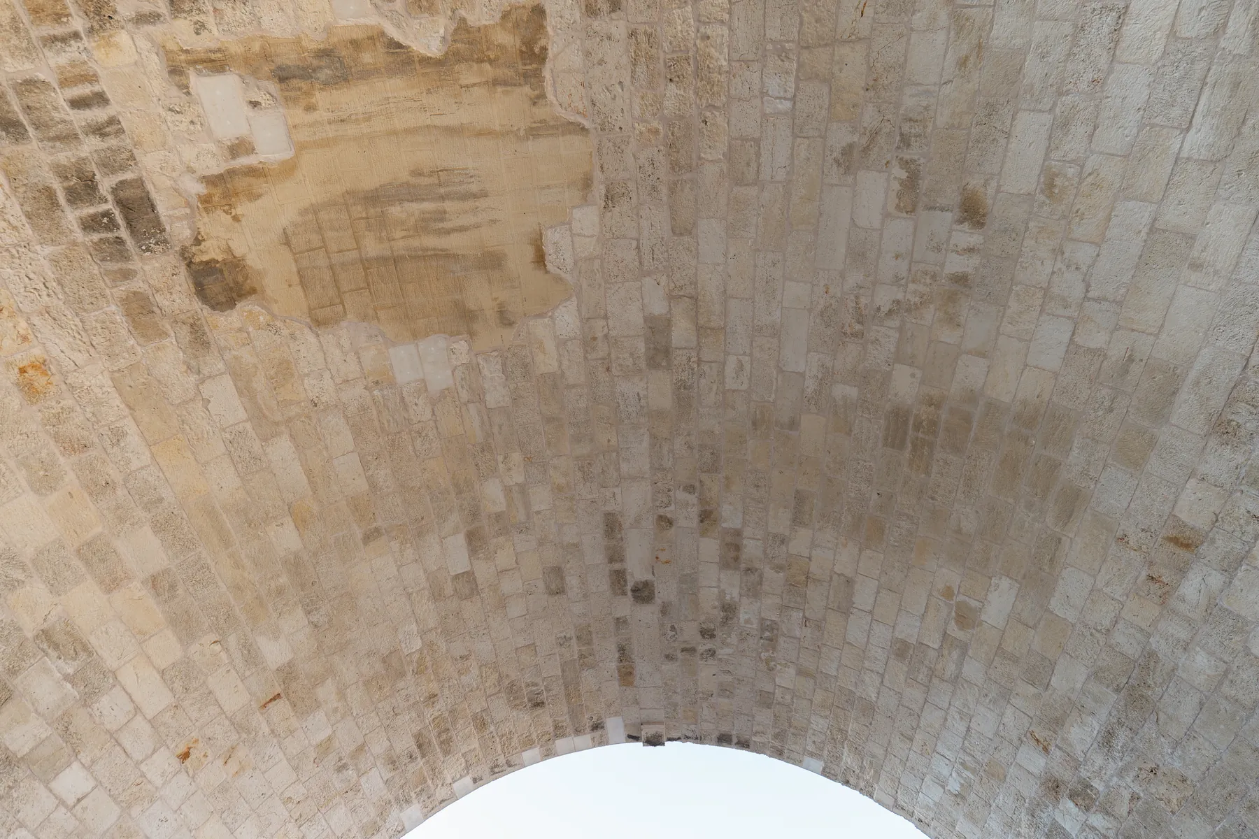 The underside of the Chanioporta arch — the restored stone vault seen from the road below