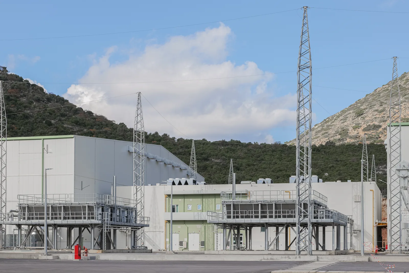 Lattice transmission pylons beside the station buildings