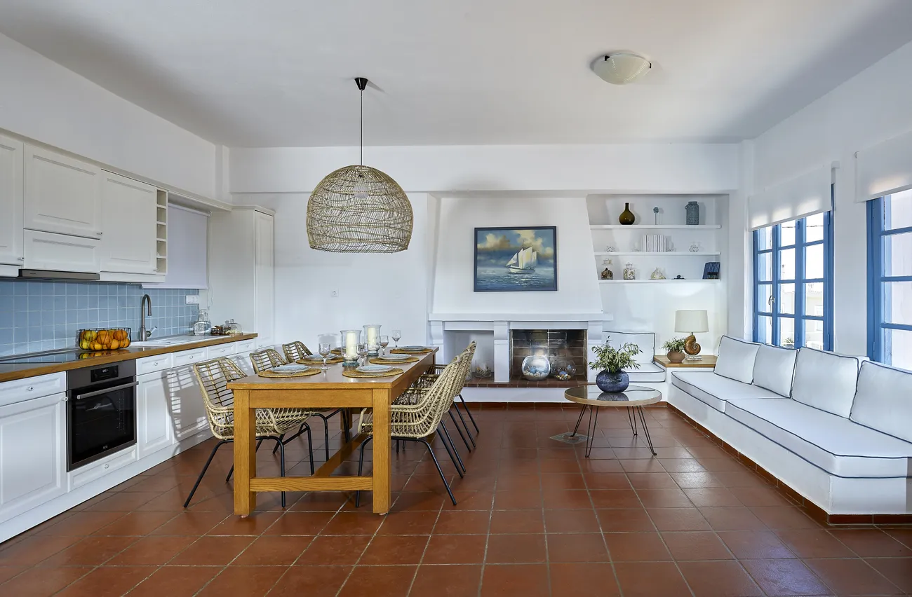 Open kitchen and dining room of Naya with terracotta floors