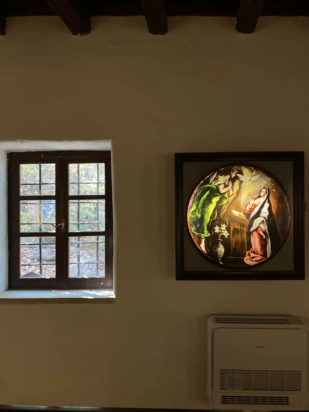 A circular El Greco work lit on the gallery wall beside a window, with one of the new air-conditioning units below