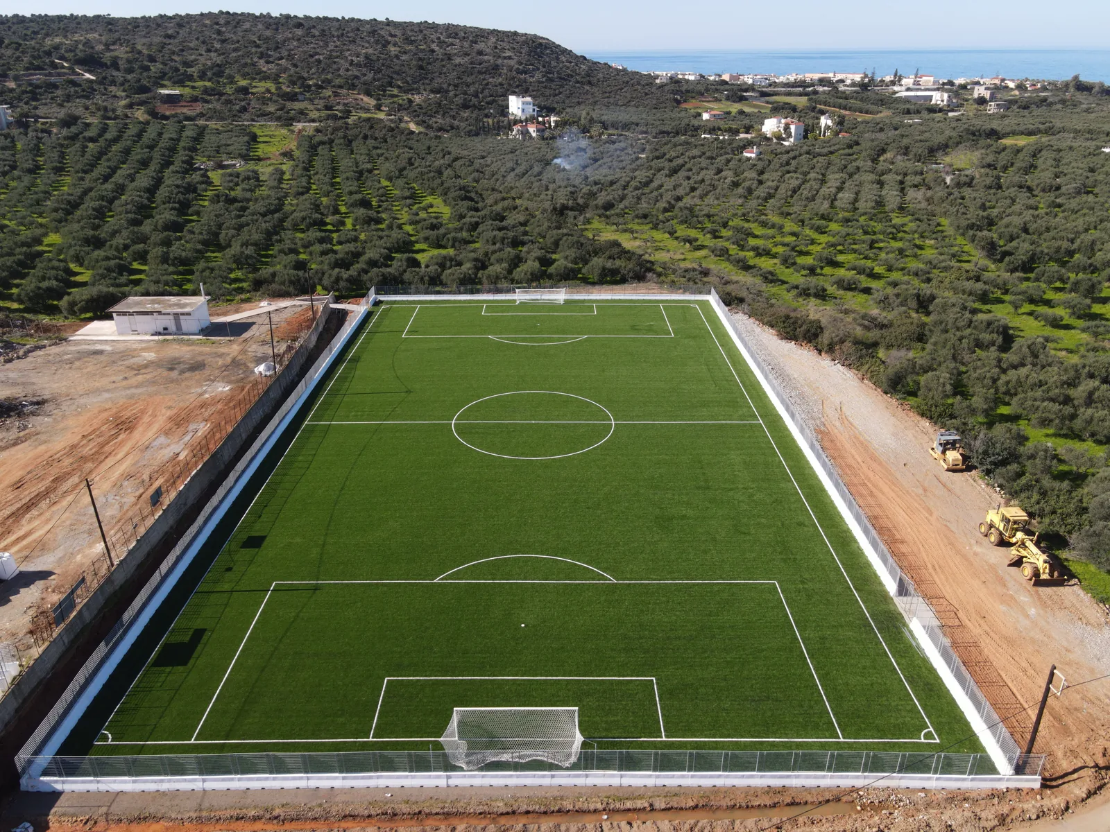 Close aerial view of the new synthetic turf and perimeter wall at Sisi during works