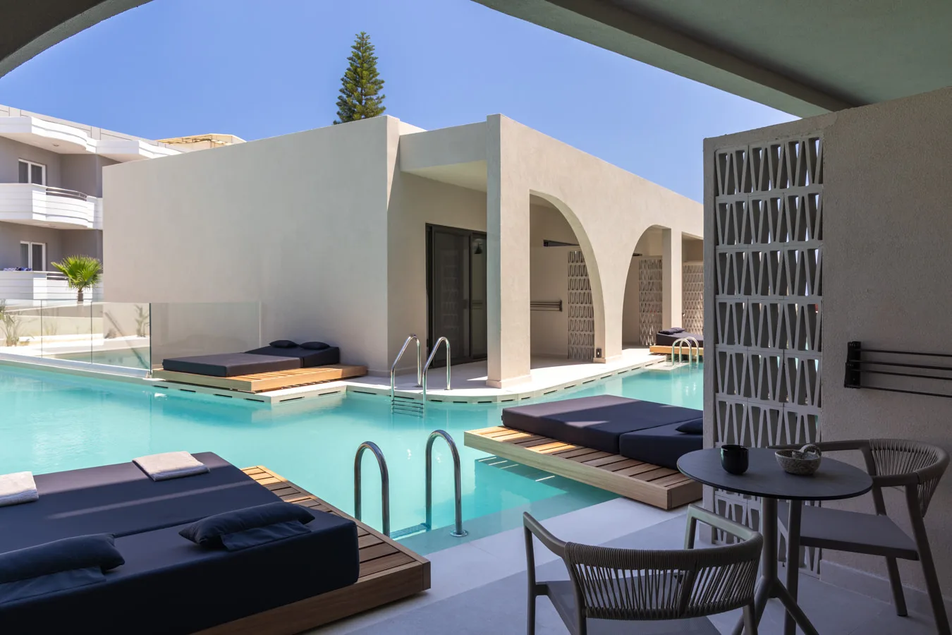 Swim-up suite terrace with day beds beside the pool