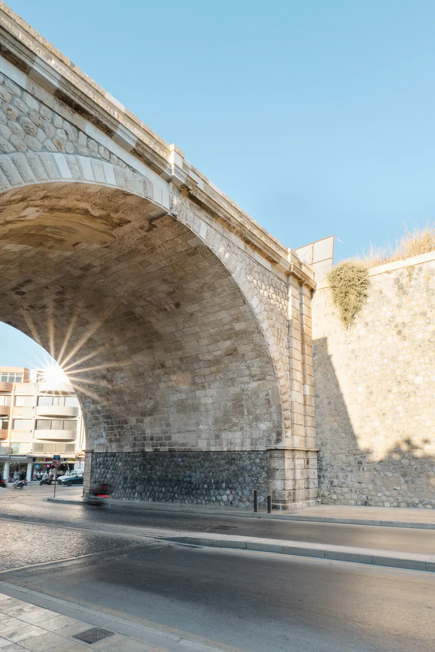 Low view of the restored arch with the sun breaking through the opening