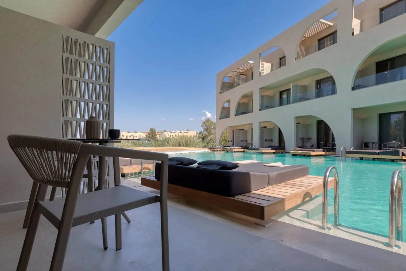 Pool bar terrace overlooking the arched facade
