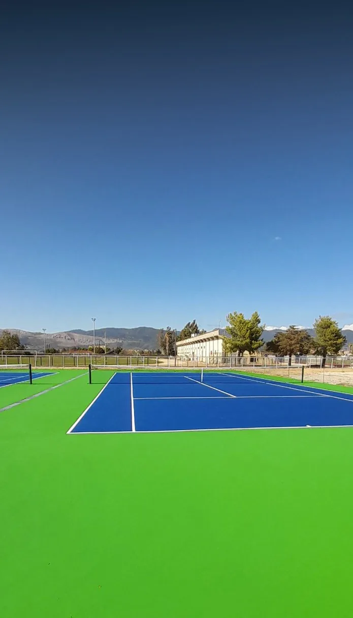 Wide view of the new blue and green acrylic tennis courts