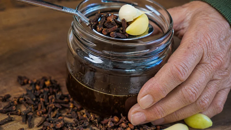Jar of cloves steeping in honey, old home remedy