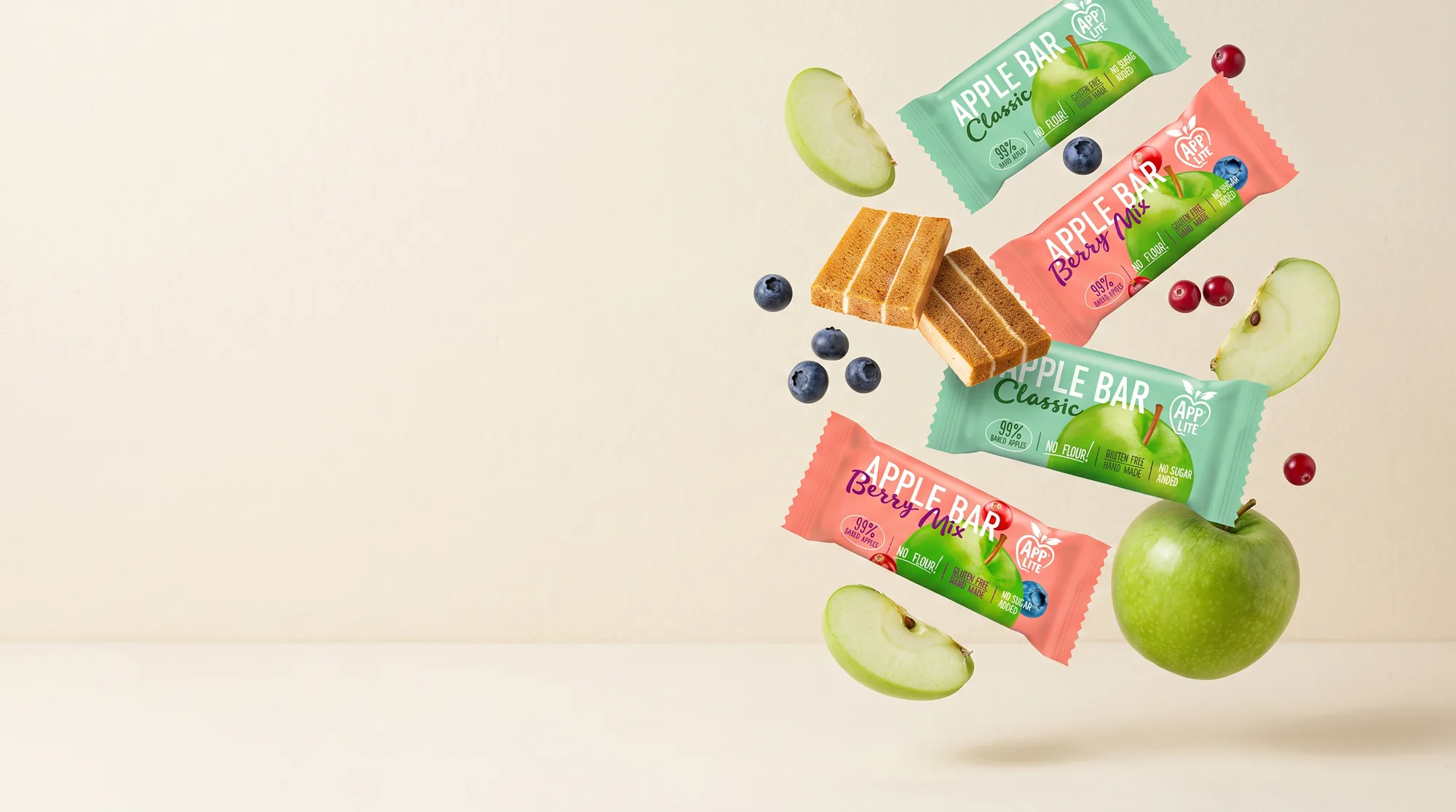 Apple Bar packs, apple slices and berries floating on a cream background
