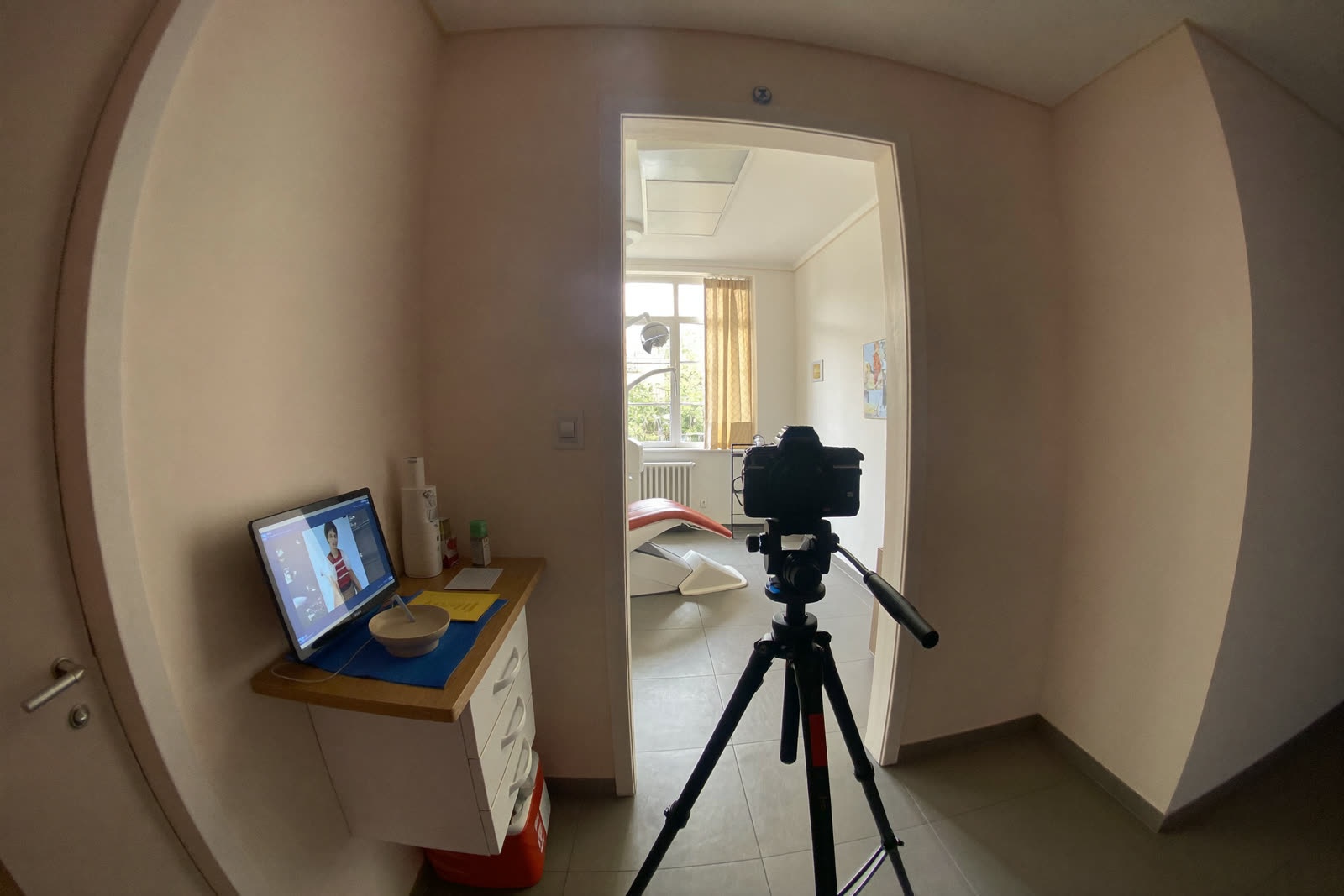 A 360-degree camera on a tripod in a modern dental office lobby