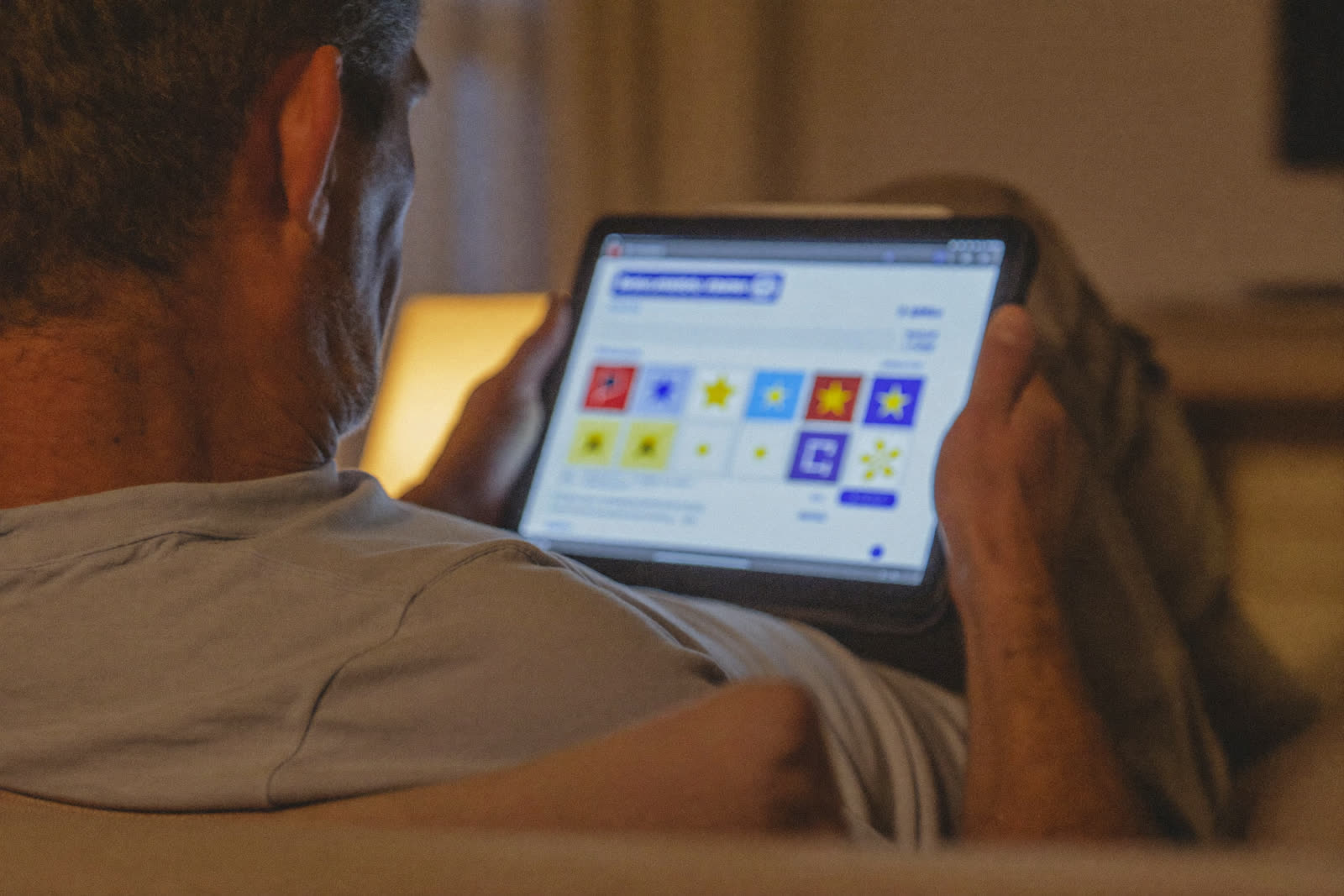 A patient reading a dental practice's reviews and photos on a tablet