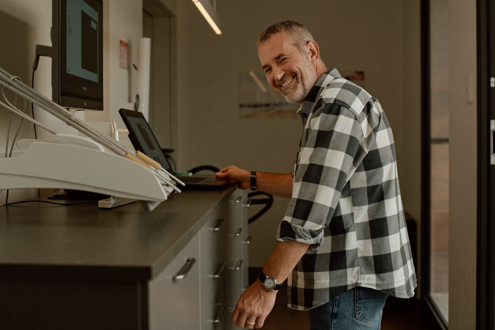 A patient checking in at a dental front desk