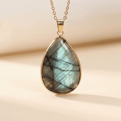 The labradorite turning in the light so the flash moves across the stone