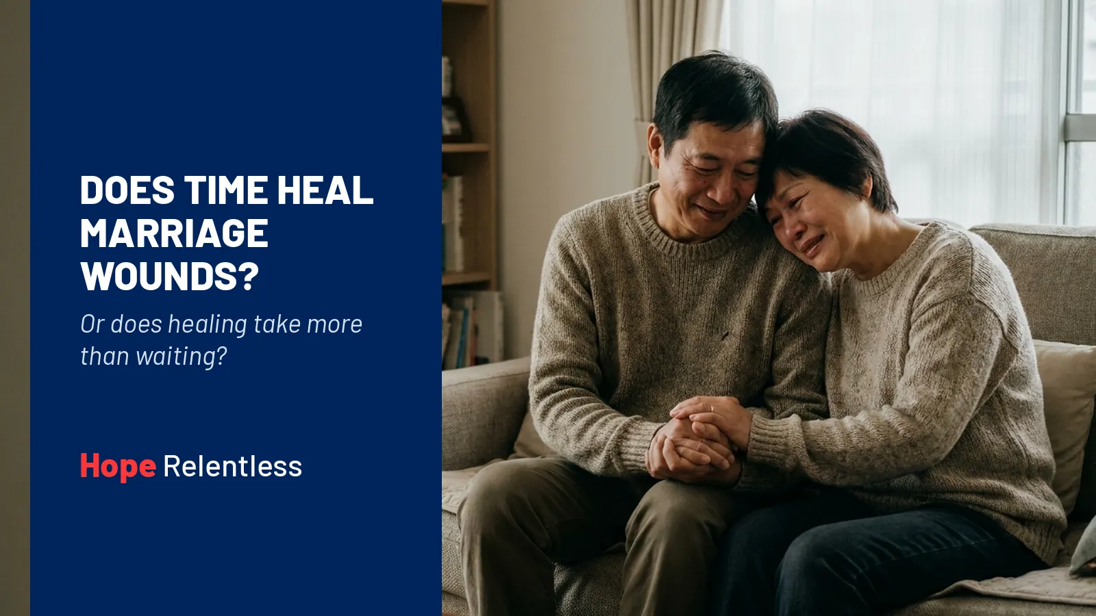 Asian couple in their 50s holding hands on a couch in a tender moment of repair, showing that healing takes more than time