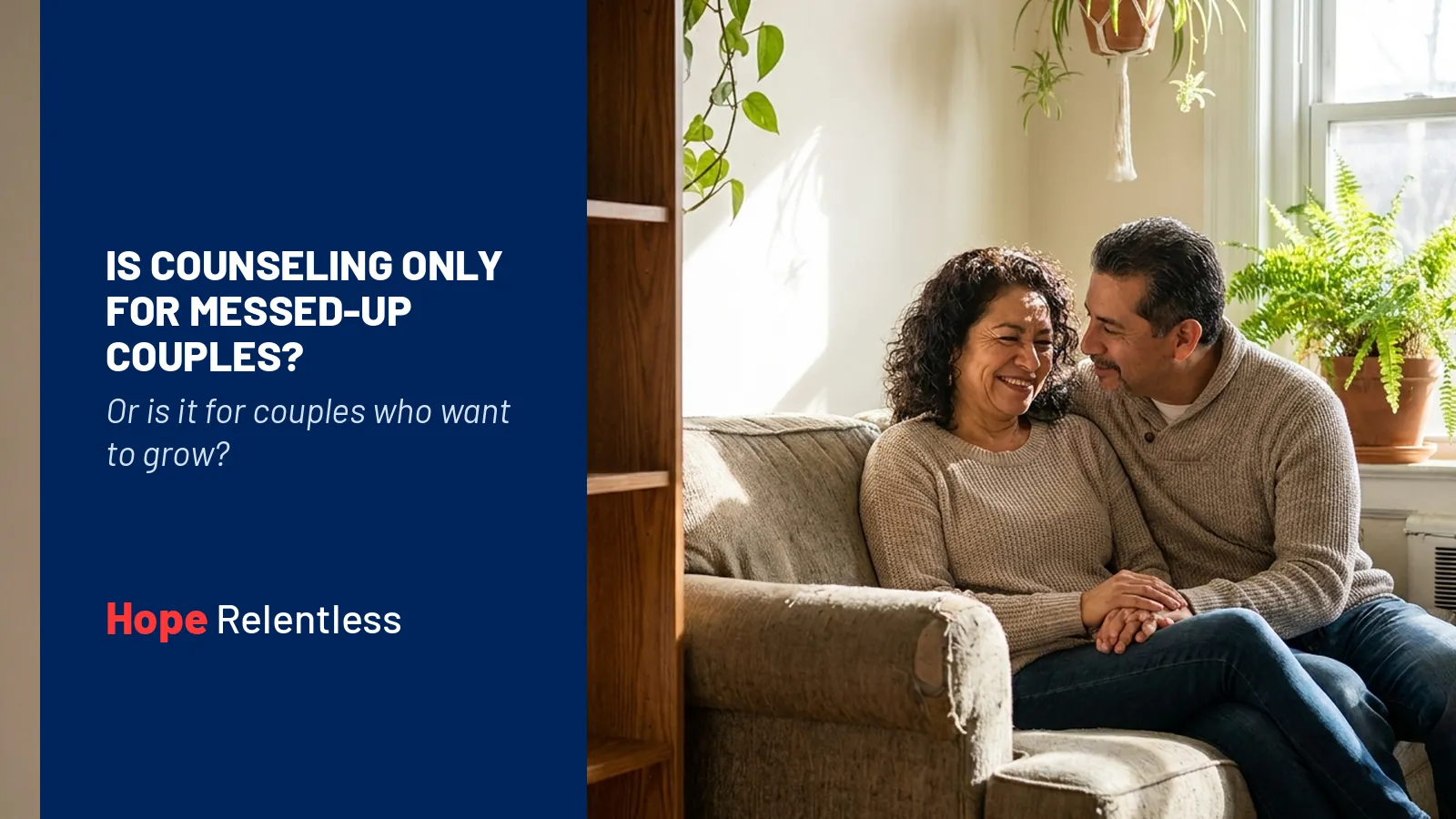 Latino couple in their 50s sitting close and laughing together on a couch, showing that marriage counseling is for growing couples too