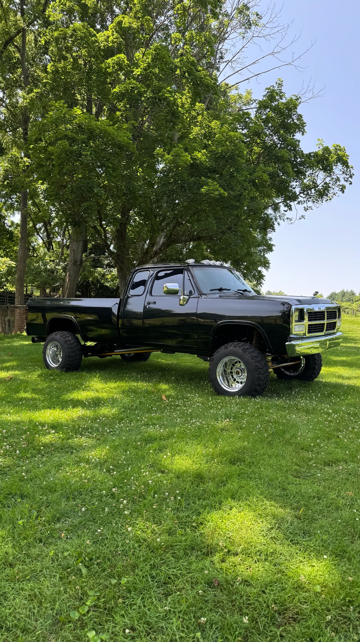 Lifted black Dodge Ram with Shifted Forged Wheels on lawn