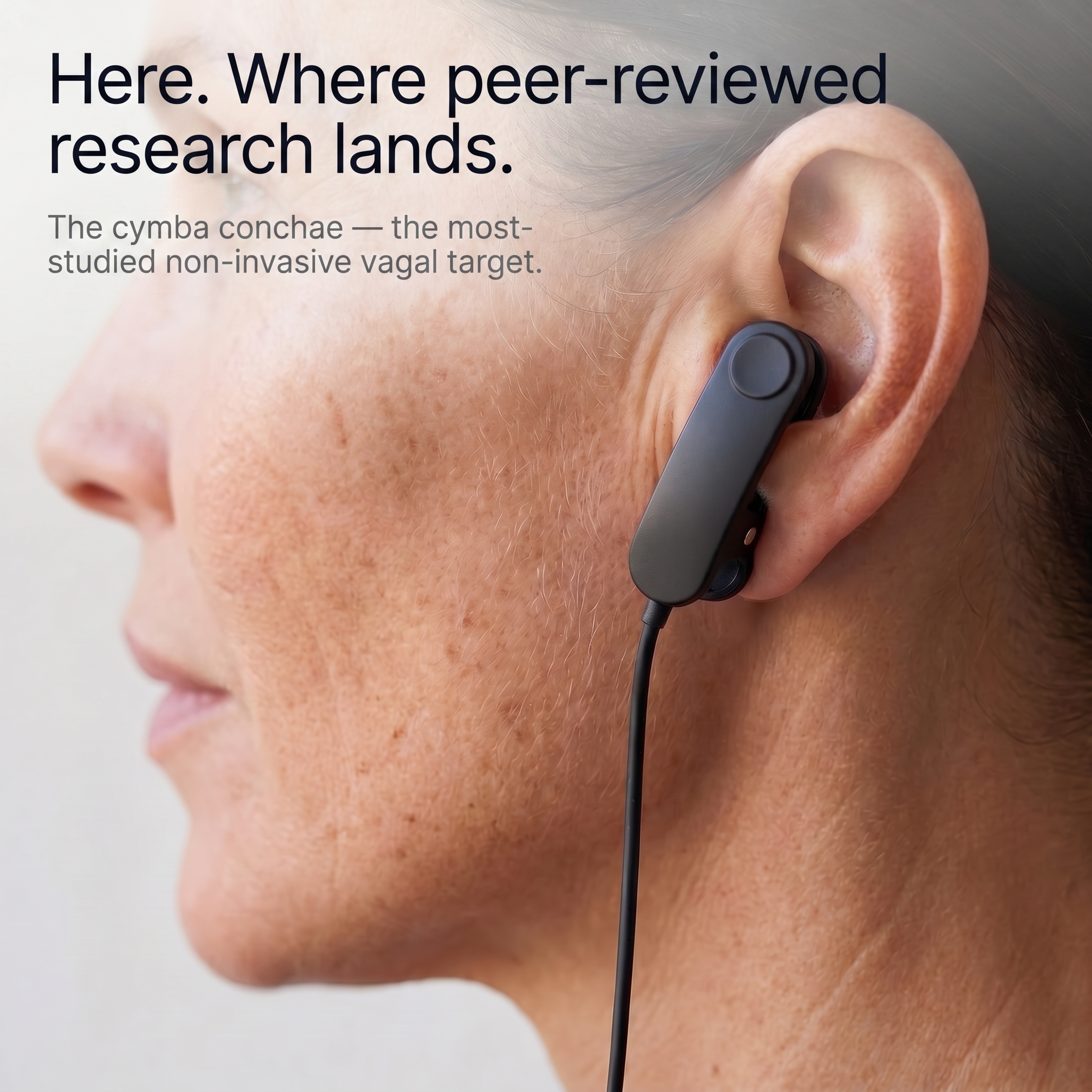 Close-up profile of a woman wearing the Lull ear-clip on her cymba conchae, the auricular branch target.