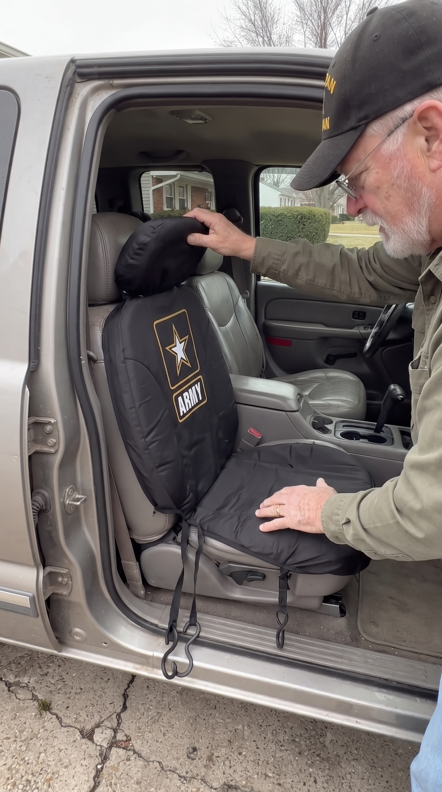 Veteran fitting a seat cover onto his truck seat
