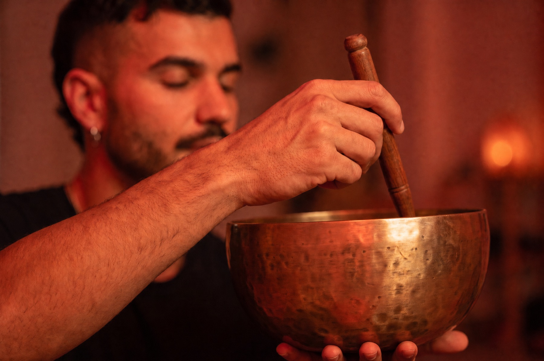 A crystal singing bowl played by hand at a moon sound bath in Windsor, Melbourne