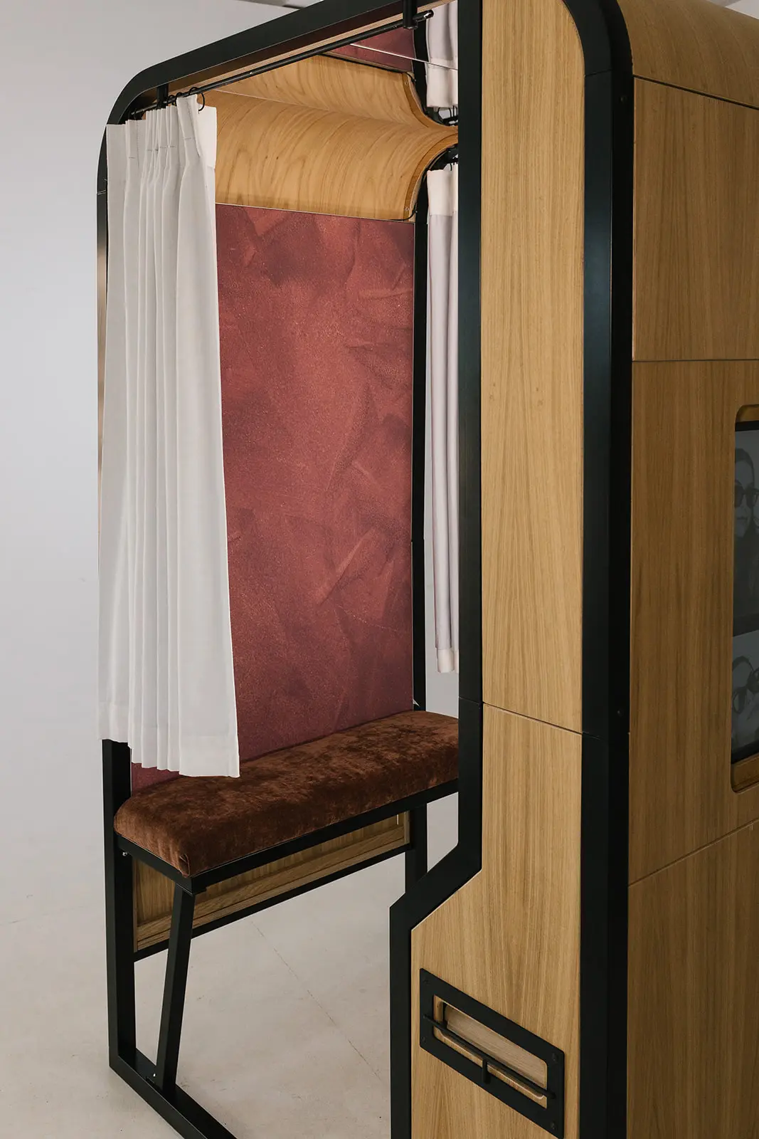 Inside The Revival: oxblood backdrop, rust velvet bench and ivory curtain under a curved oak ceiling