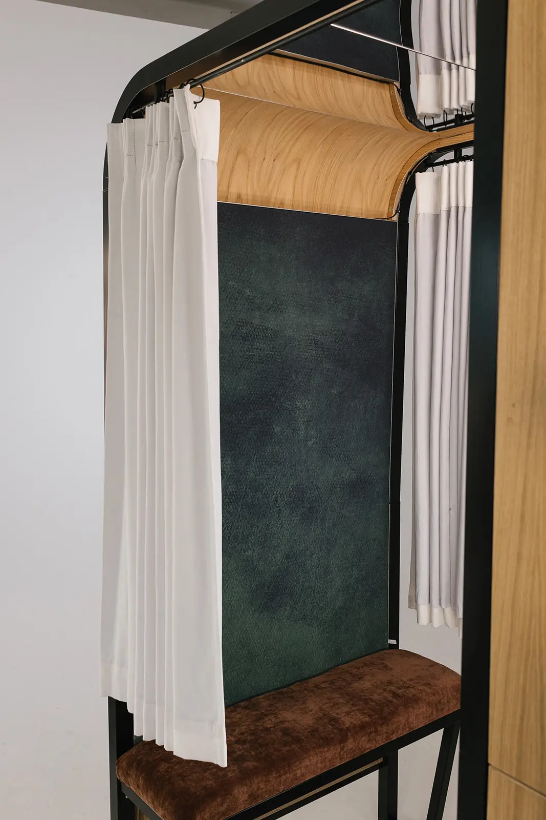 The Revival's ivory curtain, oak panels and velvet bench