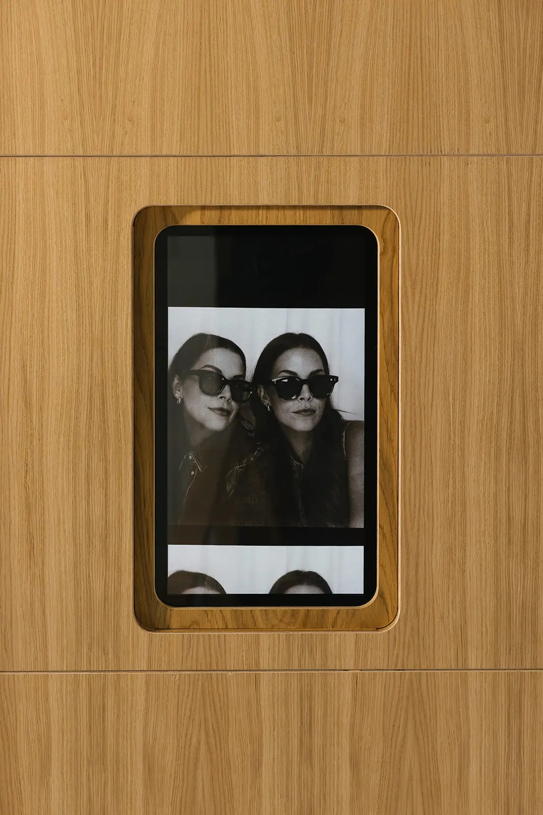 Black and white photo strip playing on the booth's external screen