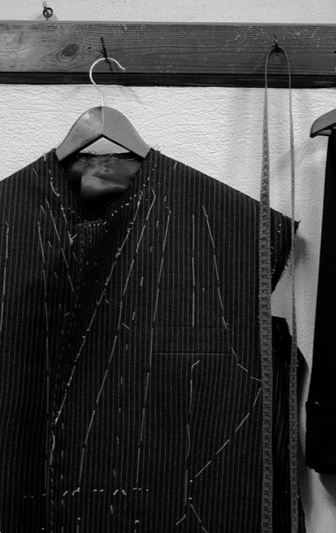 Tailor examining a jacket
