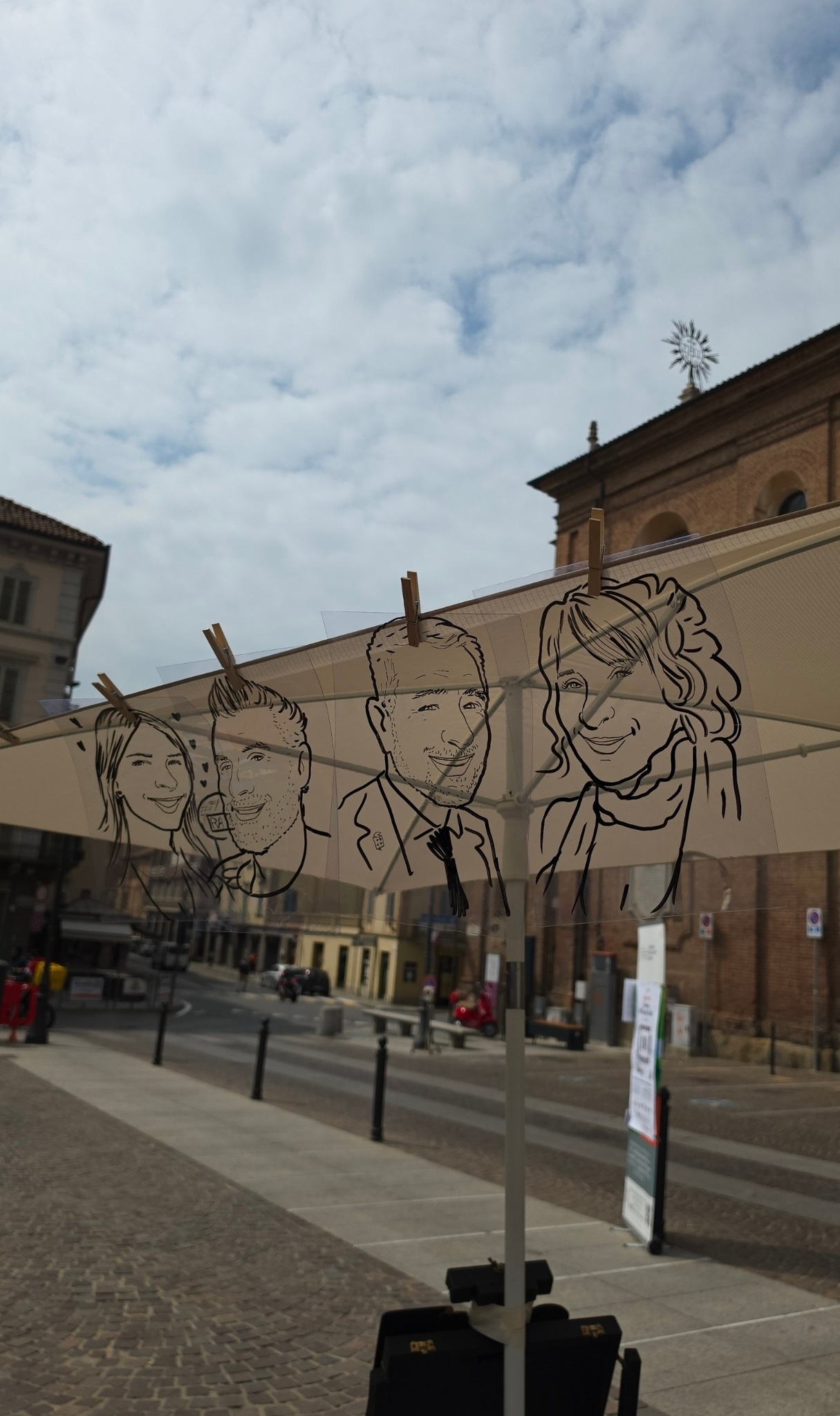 Le caricature in trasparenza appese all’ombrellone