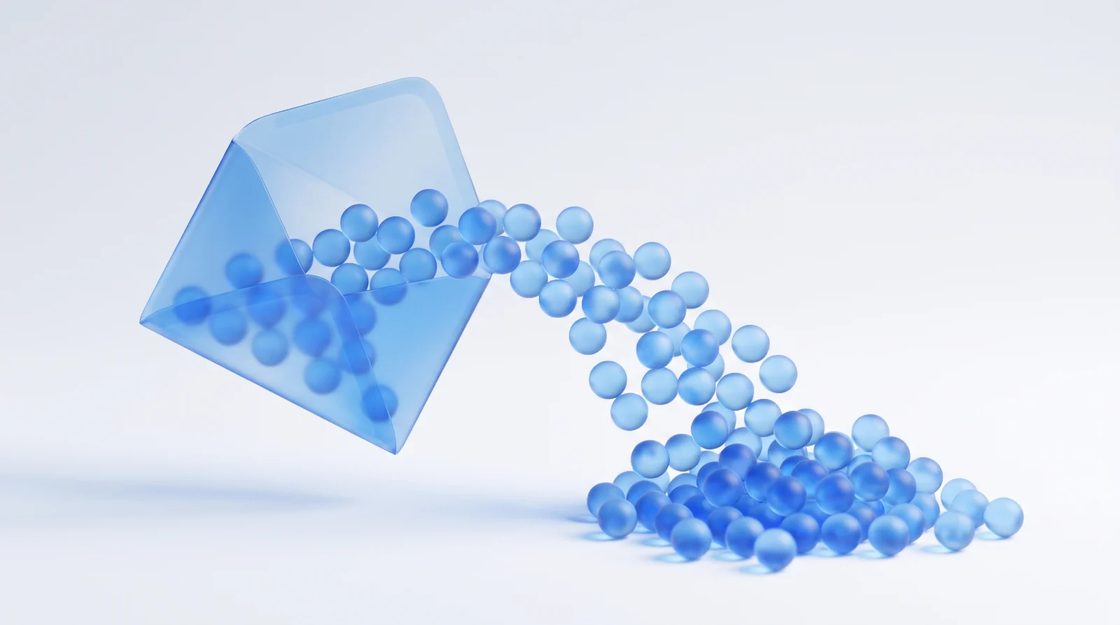 An open translucent blue glass envelope with dozens of small blue glass spheres pouring out of it