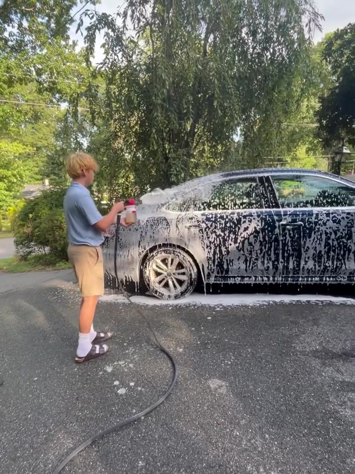 Michael foaming the side of a sedan in a Southborough driveway
