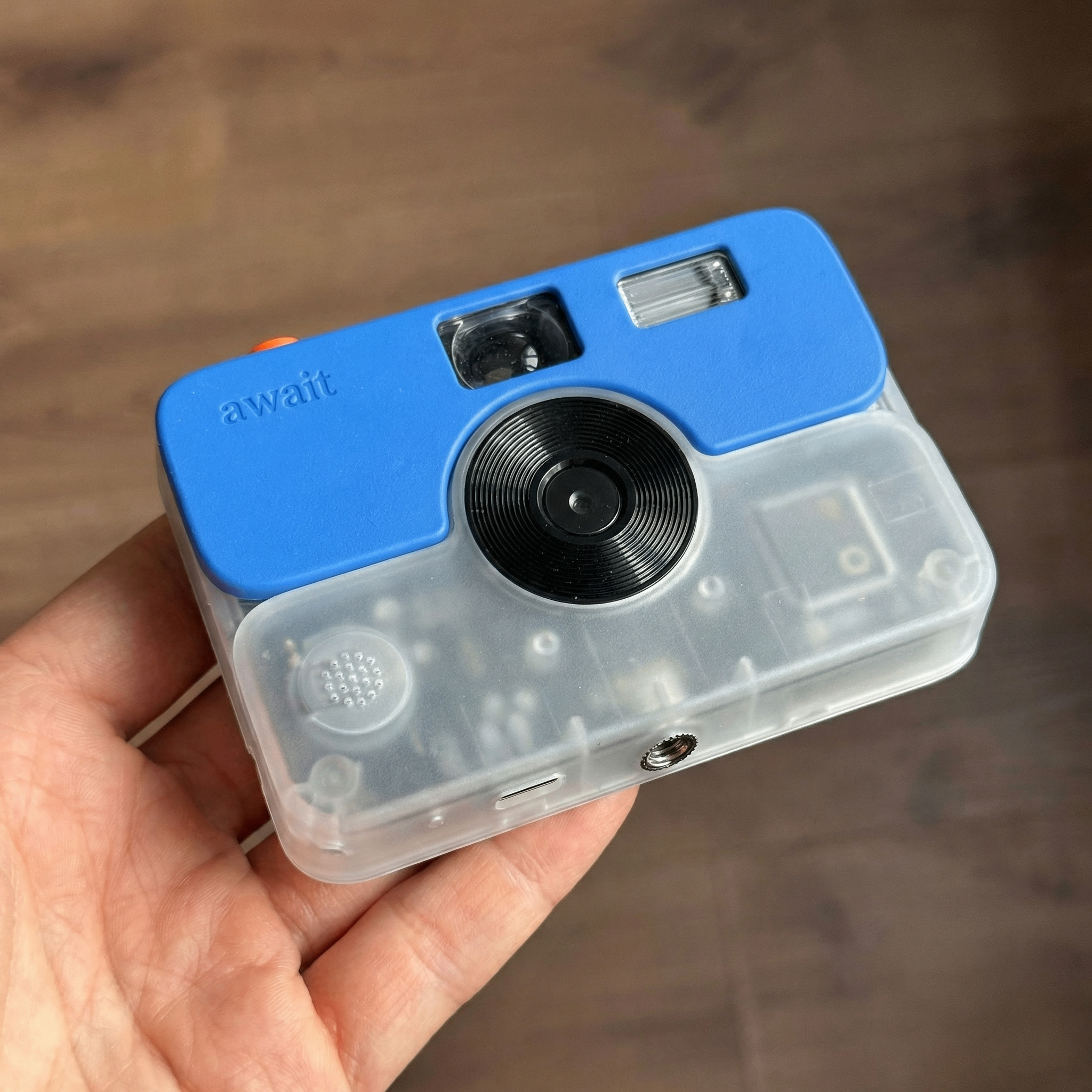 Front detail of the Await camera showing the lens, flash and viewfinder
