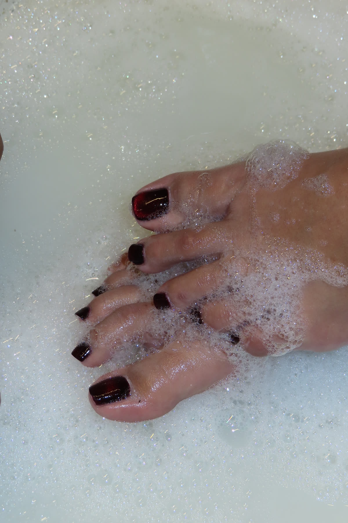 Cat-eye gel pedicure during a foam soak at Serené Beauté Studio