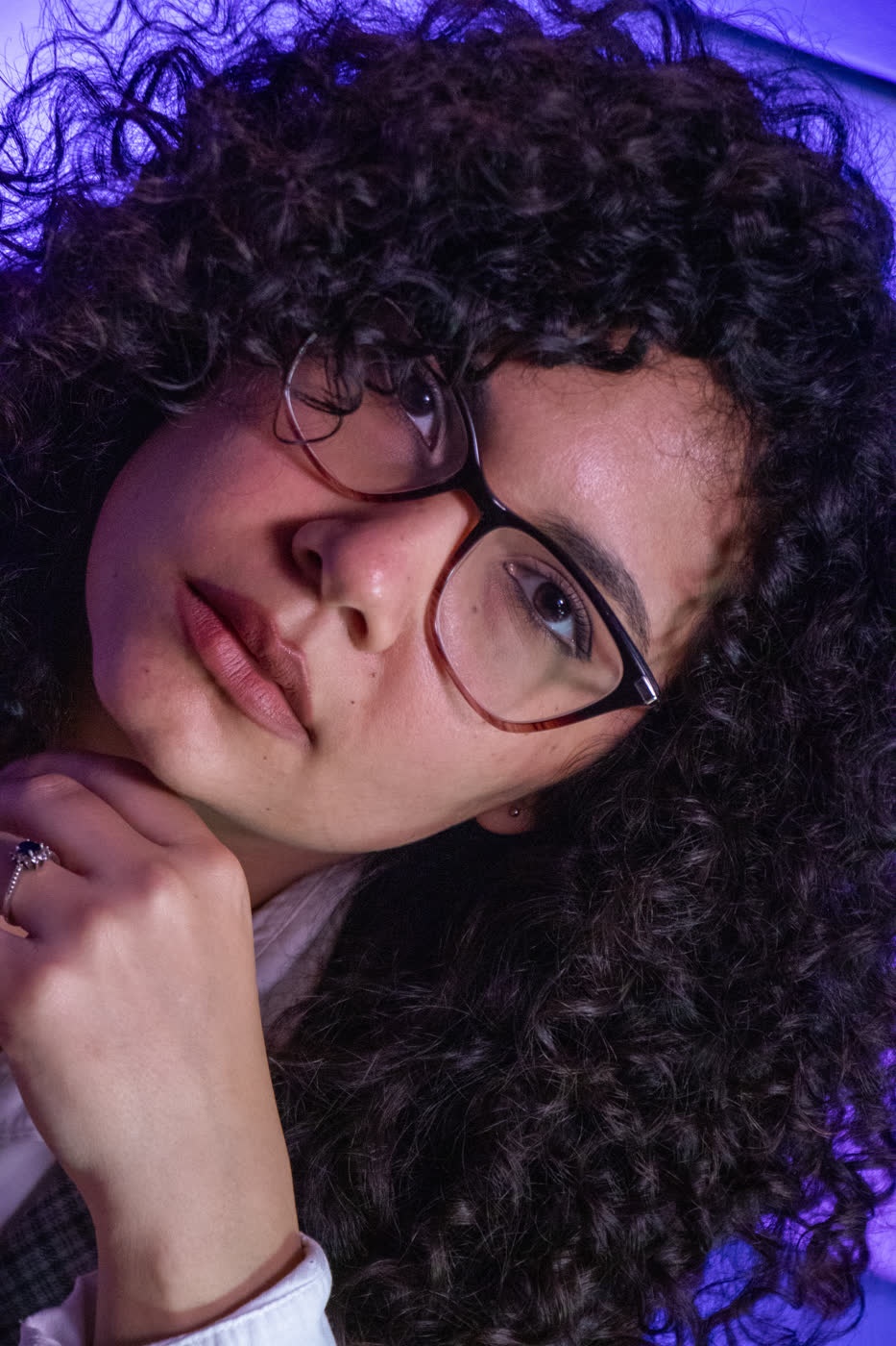 Renata pensativa com a mão no queixo