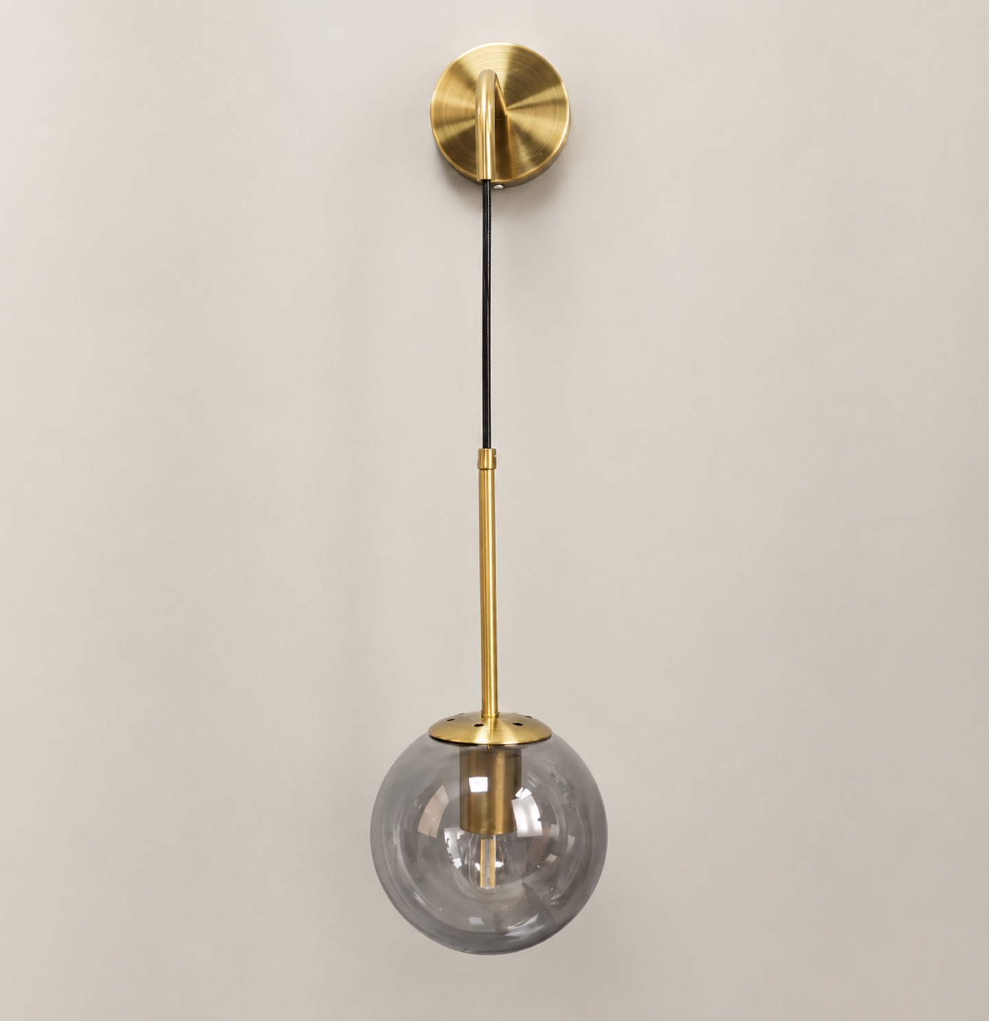 Brass wall sconce with smoked glass globe pendant