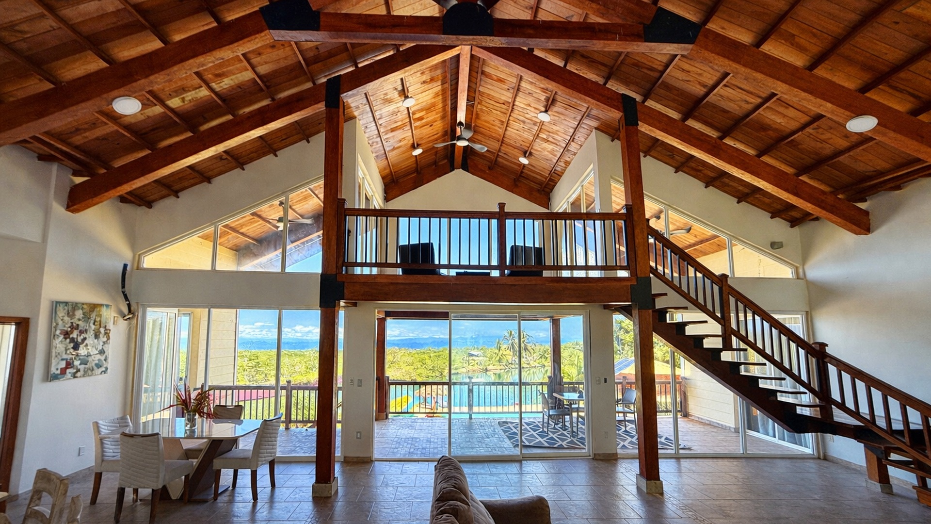 The great room, vaulted wooden ceiling and staircase