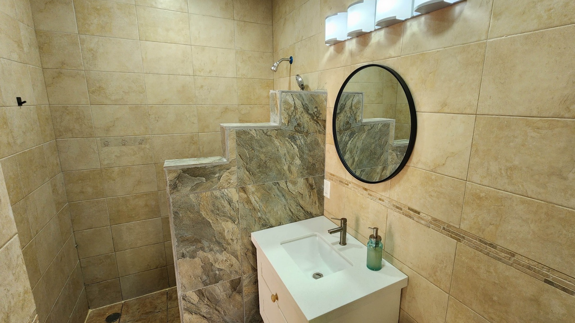 Stone walk-in shower and vanity