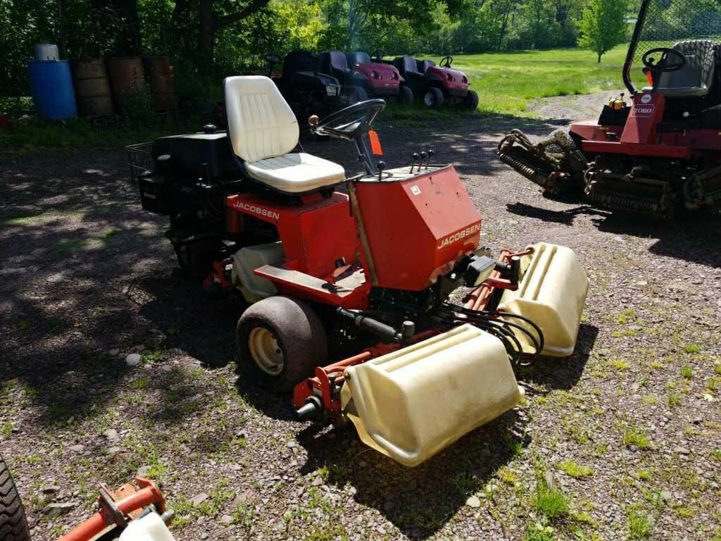 Jacobsen and Toro reel mowers lined up on a gravel lot for a Cowley on-site equipment auction