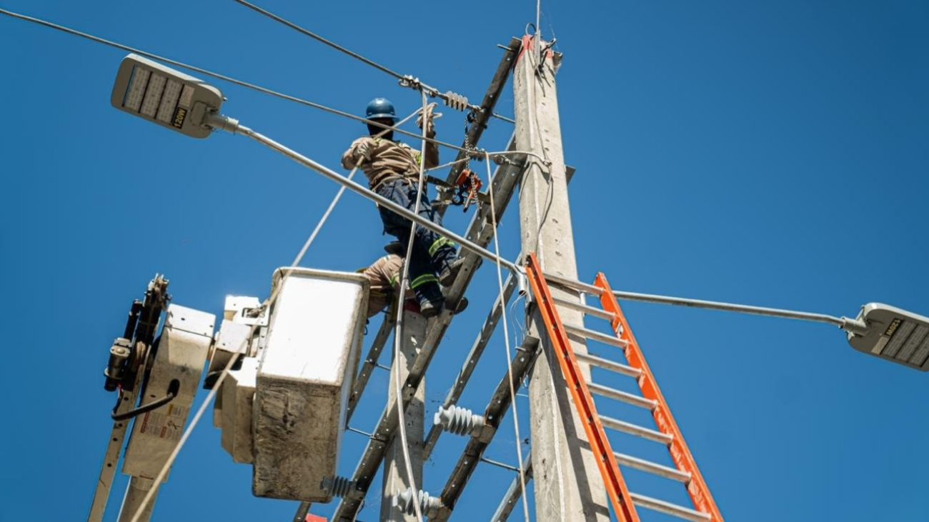 Técnicos de Edesur trabajando en un poste de la red eléctrica