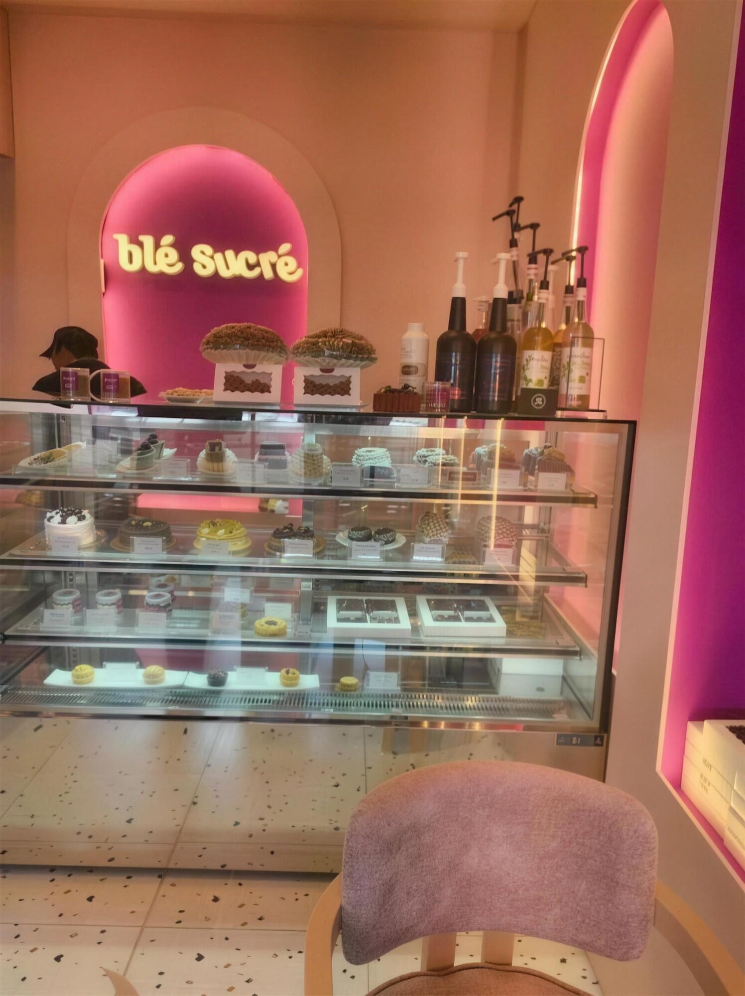 Inside our Madinat Al Umal shop, the dessert counter under the pink neon Ble Sucre sign