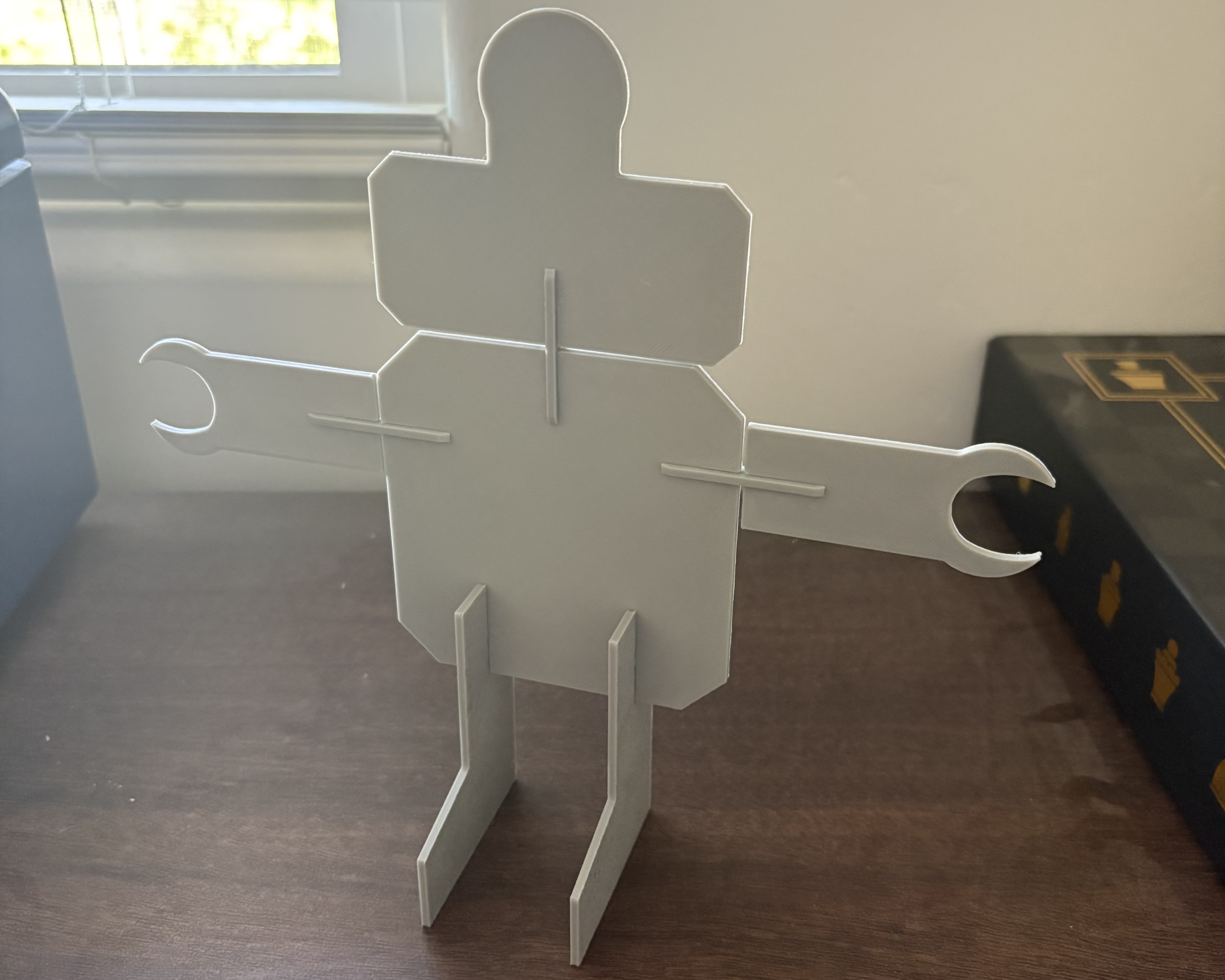 Screen-free STEM robot project with arms and legs made from cage cardboard