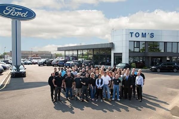 The Tom's Ford team standing together in front of the Keyport dealership