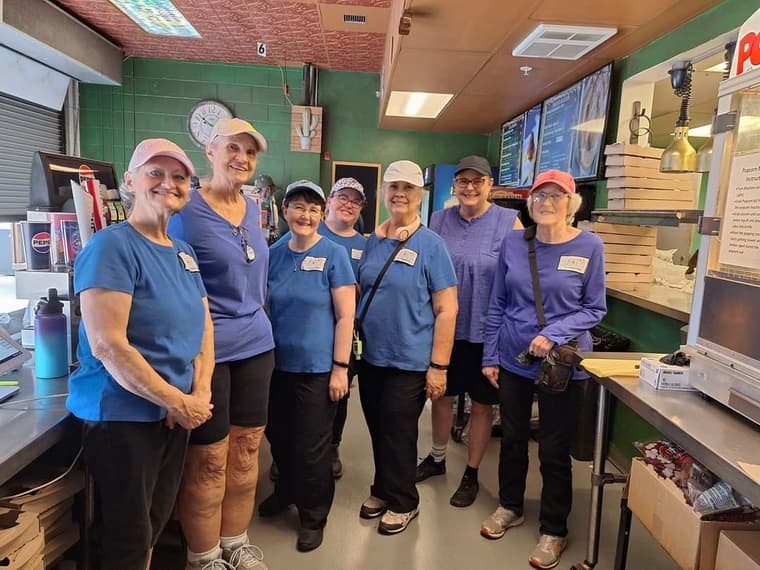 Members volunteering together behind a concession counter