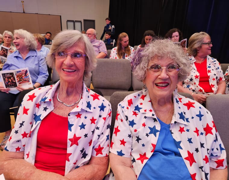 Two members in star-patterned shirts backstage
