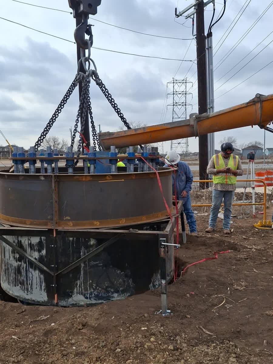 Steel anchor bolt template being lifted by crane