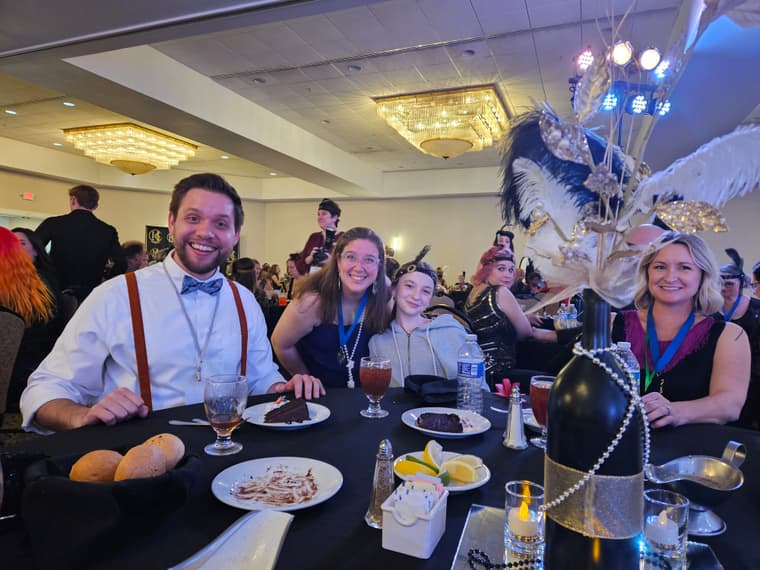 The director and members at a themed convention dinner