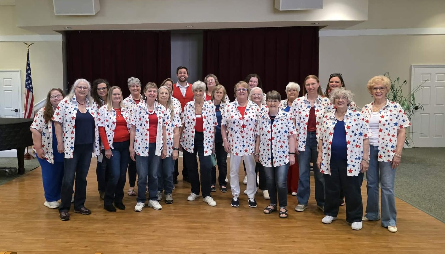 The chorus performing in star-patterned shirts at Azalea Trace