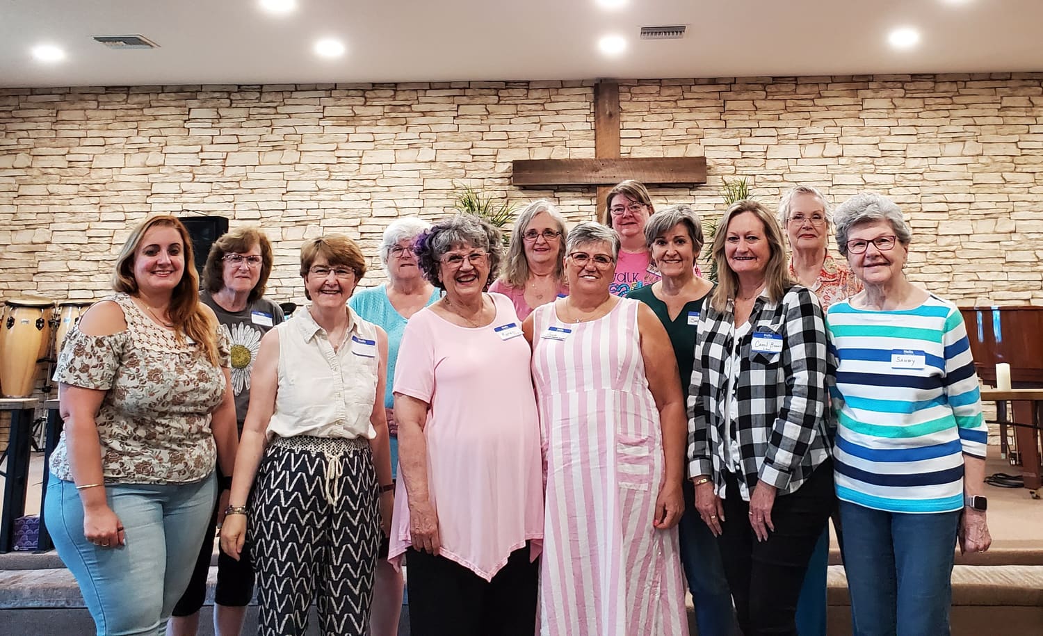 The group at their very first rehearsal in July 2022, standing together and smiling