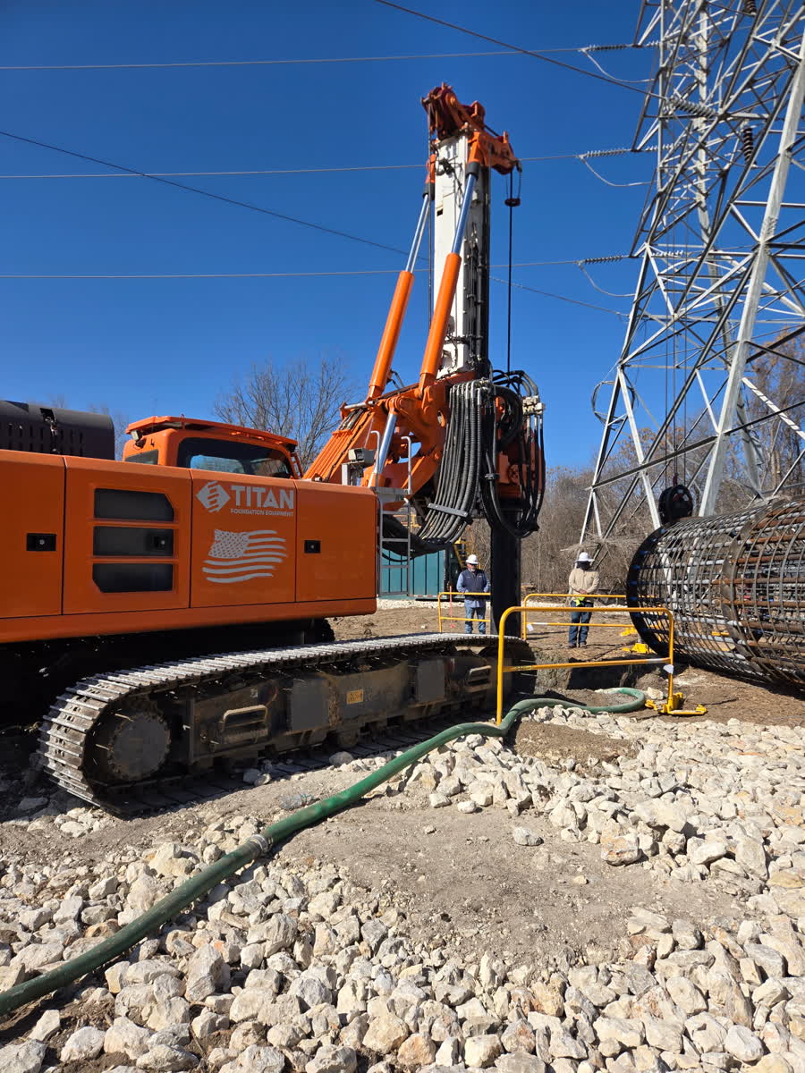 Drill rig working at the base of a communications tower