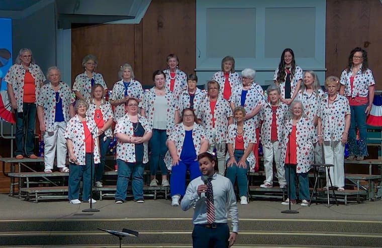 The chorus on risers in star-patterned shirts